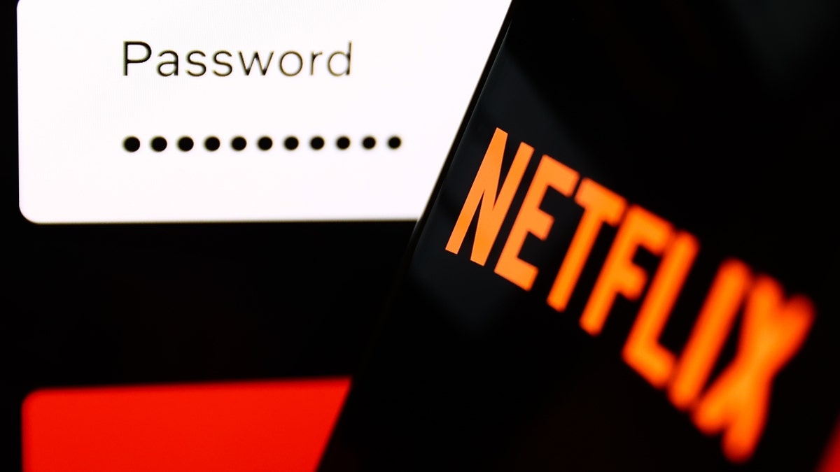 The Netflix sign-in page displayed on a laptop screen and the Netflix logo on a phone screen