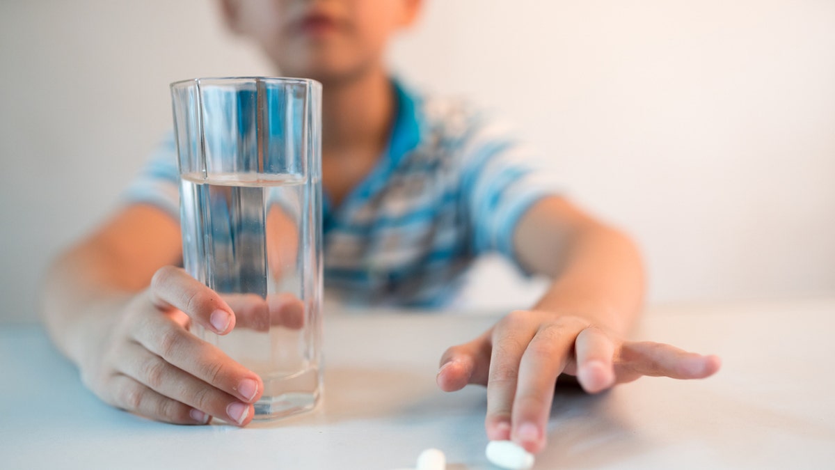 Boy taking pills