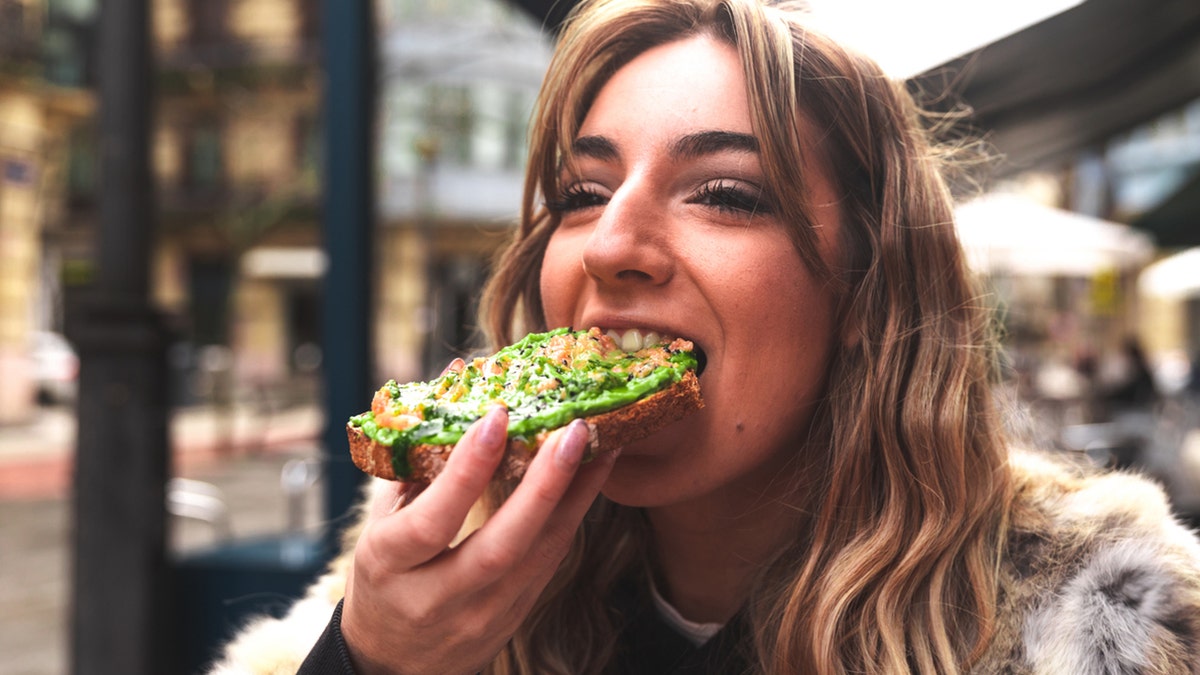 woman eats avocado toast