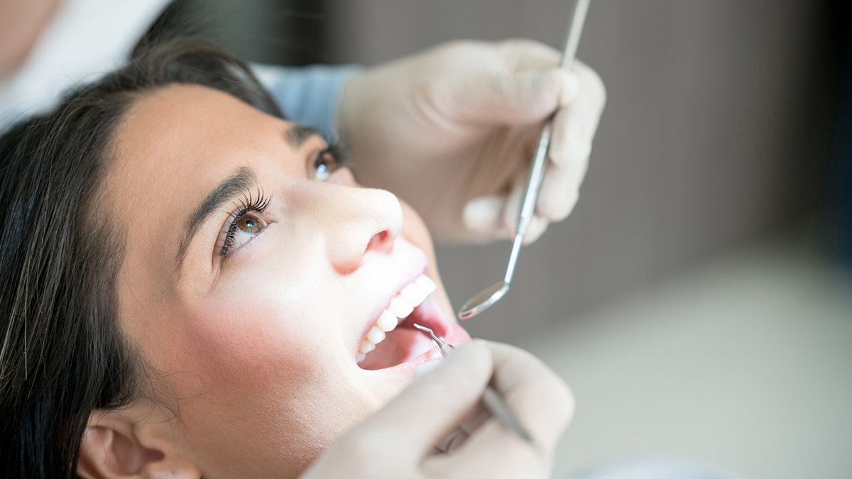 woman gets her teeth checked at the dentist