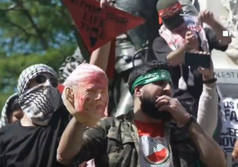 Anti-Israel agitator in Hamas headband holds up bloodied Biden face mask steps from White House