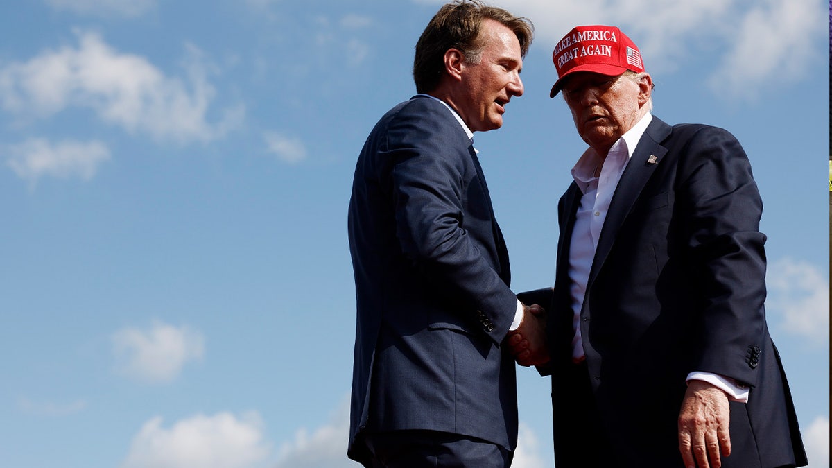 Former U.S.  President Donald Trump shakes hands with Virginia Gov. Glenn Youngkin