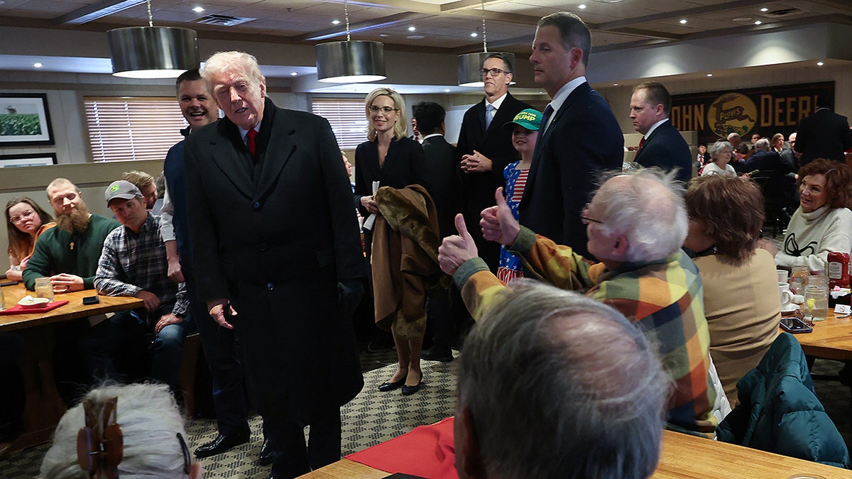 Donald Trump greeted by supporters