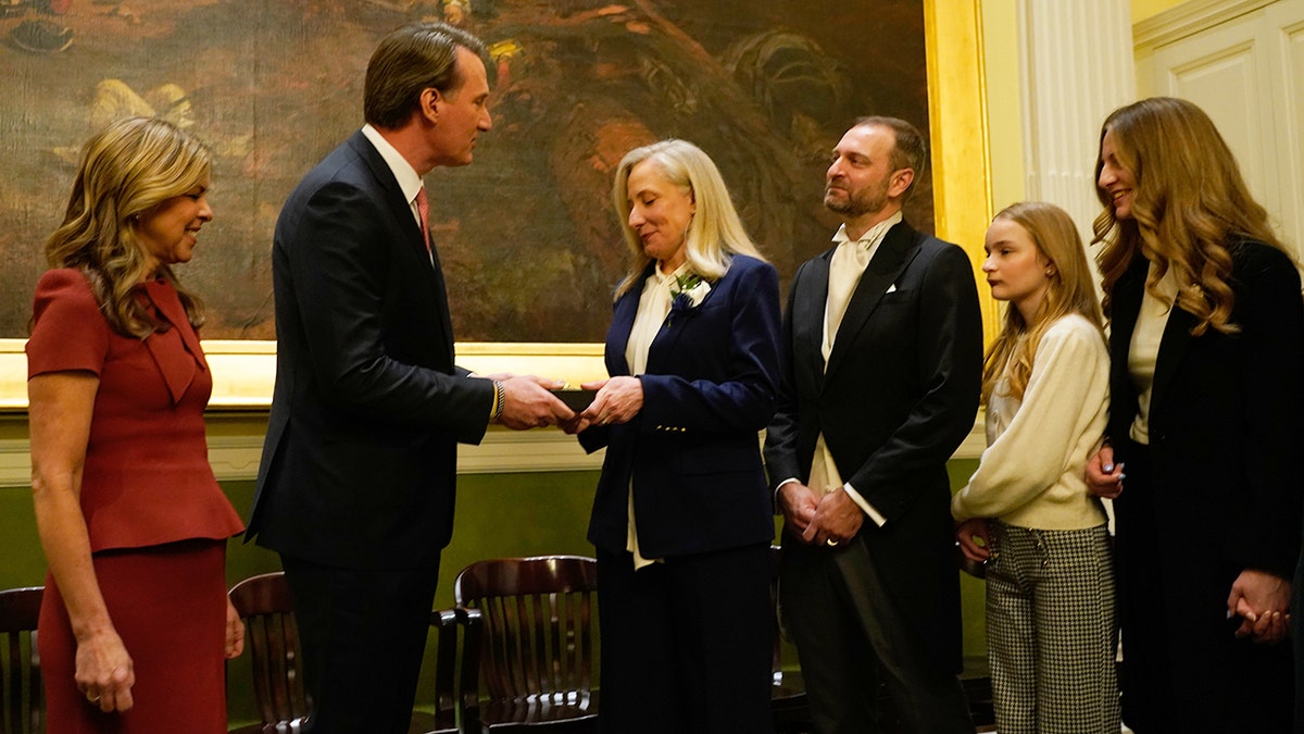 Abigale Spanberger and Glenn Youngkin participate in key ceremony