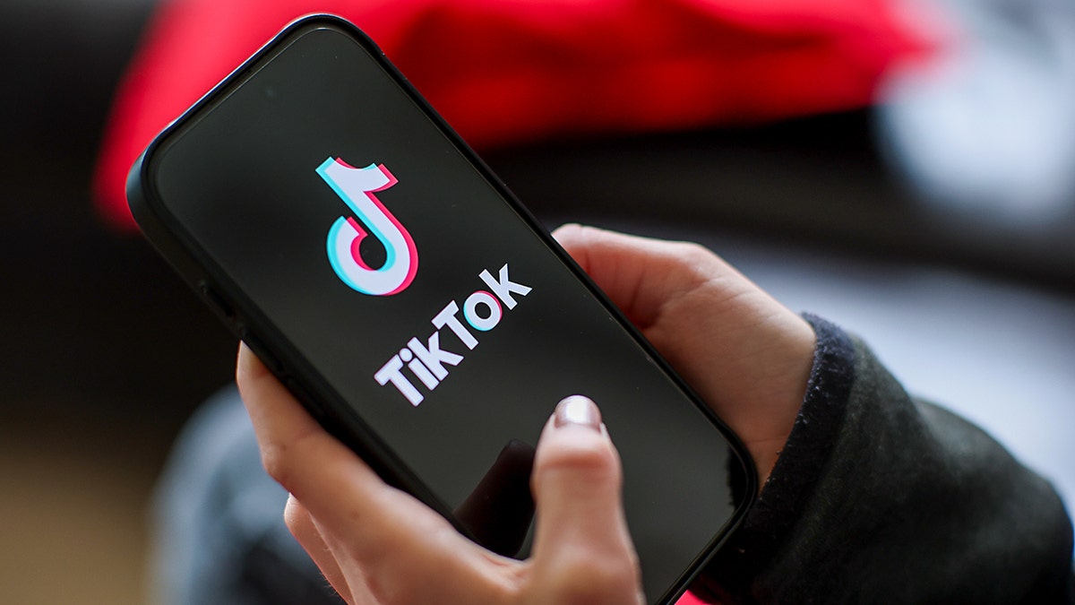 Woman typing on a phone.