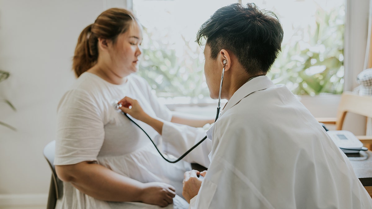 Doctor listens to patient's heartbeat