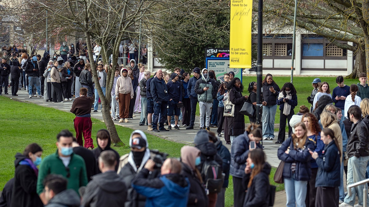 CANTERBURY, ENGLAND - MARCH 16: Staff and students, some wearing face masks, queue to receive antibiotics at the University of Kent in Canterbury after an outbreak of meningitis caused the deaths of two people, on March 16, 2026 in Canterbury.