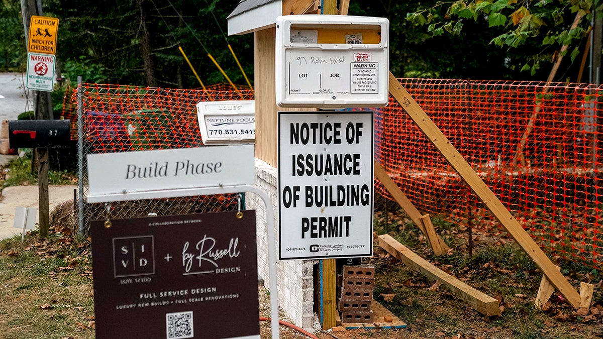 A sign reads, "Notice of issuance of building permit" in front of construction.